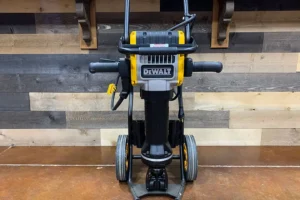 Yellow DeWalt 60lb electric jack hammer standing indoors.