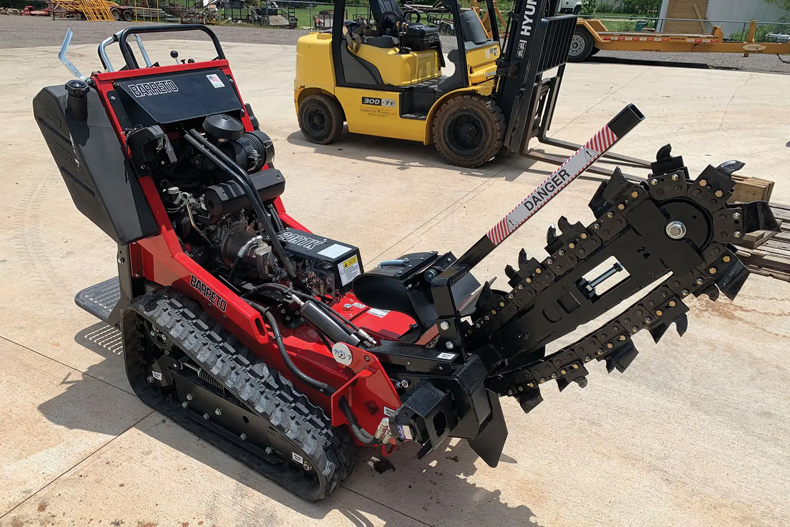 Red Barreto trencher on display outside a rental facility