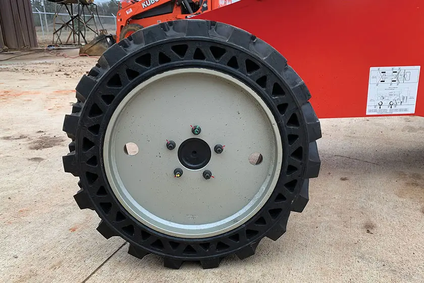 Close-up view of the rugged wheel on a Manitou manlift