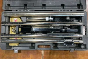 Power carpet stretcher in a black case with metal components