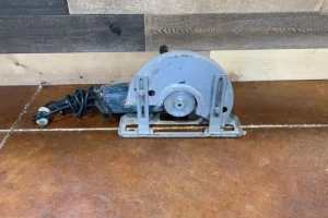 Electric circular saw with a blue and gray design on a brown floor